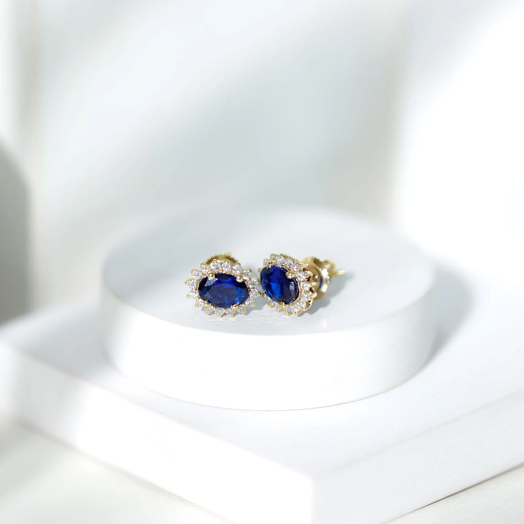 Oval Cut Created Blue Sapphire Stud Earrings with Moissanite Halo