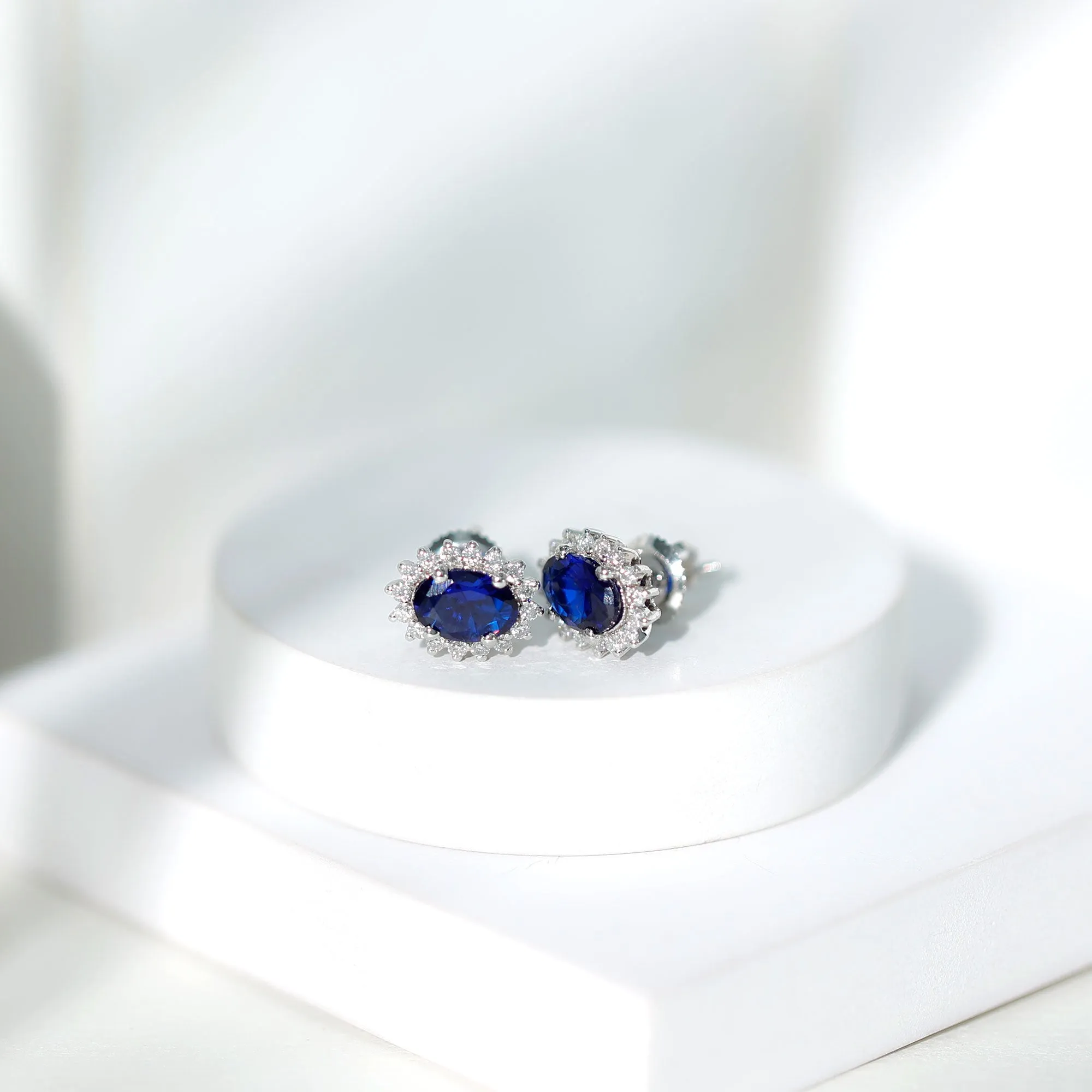 Oval Cut Created Blue Sapphire Stud Earrings with Moissanite Halo